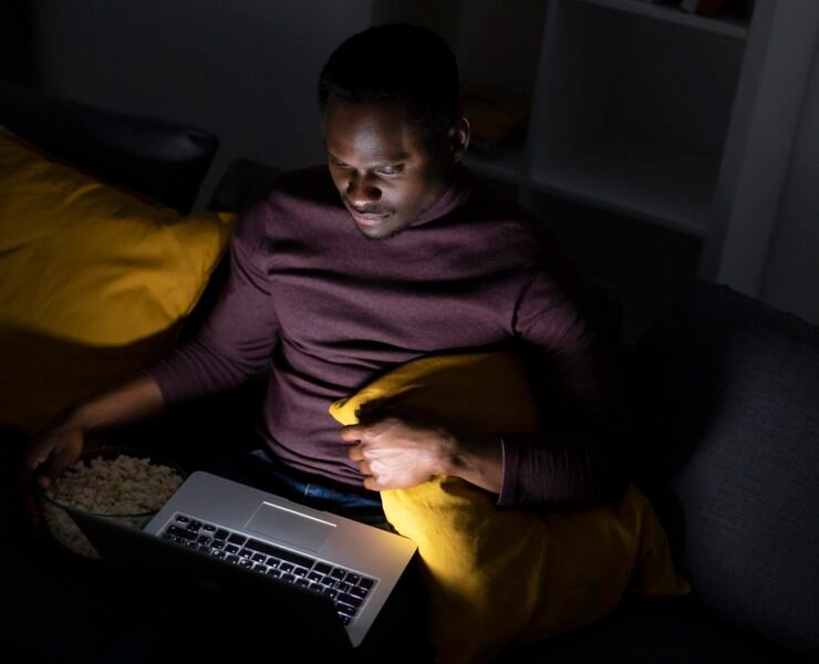 An African American man streaming a church service online